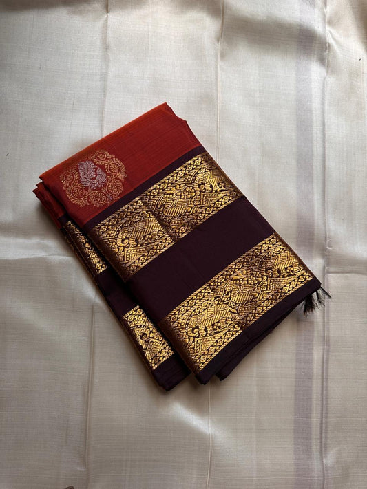 The Rust Orange Abharna: A Silk Mark Certified Kanchipuram Pure Silk Saree
with Maroon and Gold Elephant Zari Border & Rich Zari Pallu
Handwoven with Exquisite Peacock Motifs
Free Shipping within USA on this Handloom Creation
Ships in 1 Week