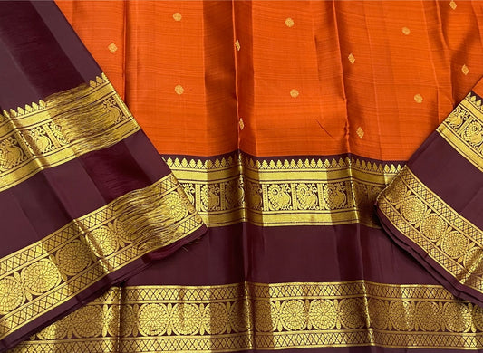 Rust Orange Ramyam – Pure Kanchipuram Silk Saree
Rust-orange body with pavin coin  buttas
Deep brown border with peacock panel & chakra medallions; grand zari pallu
Silk Mark Certified | Blouse Piece Included | Fall & Pico Done
Free Shipping in 1 week