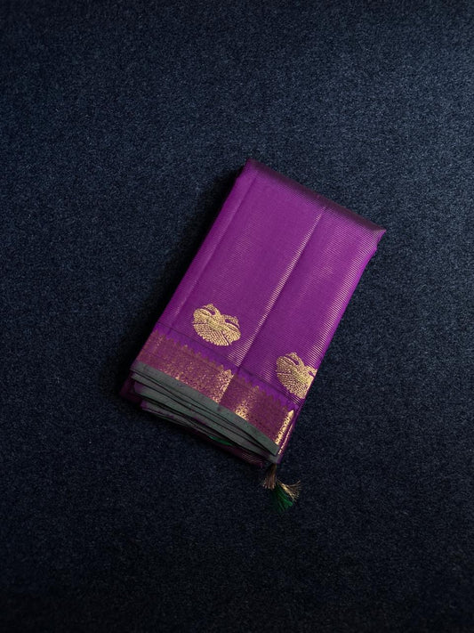 Purple Gandaberunda Vairaoosi — Pure Silk Kanchipuram Saree
Royal purple vairaoosi stripes with antique-gold Gandaberunda buttas & temple border.
Silk Mark Certified · Free USA Shipping · Ships in 2 Weeks ✨