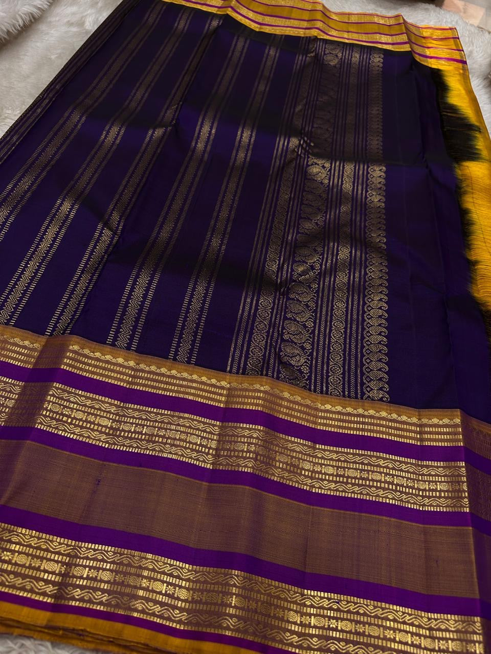 Swarna Laya — Pure Silk Kanchipuram Saree
Deep vaadamalli purple with gold zari buttas, antique-gold border, and rich striped pallu.
Silk Mark Certified • Free USA Shipping • Ships in Two Weeks.