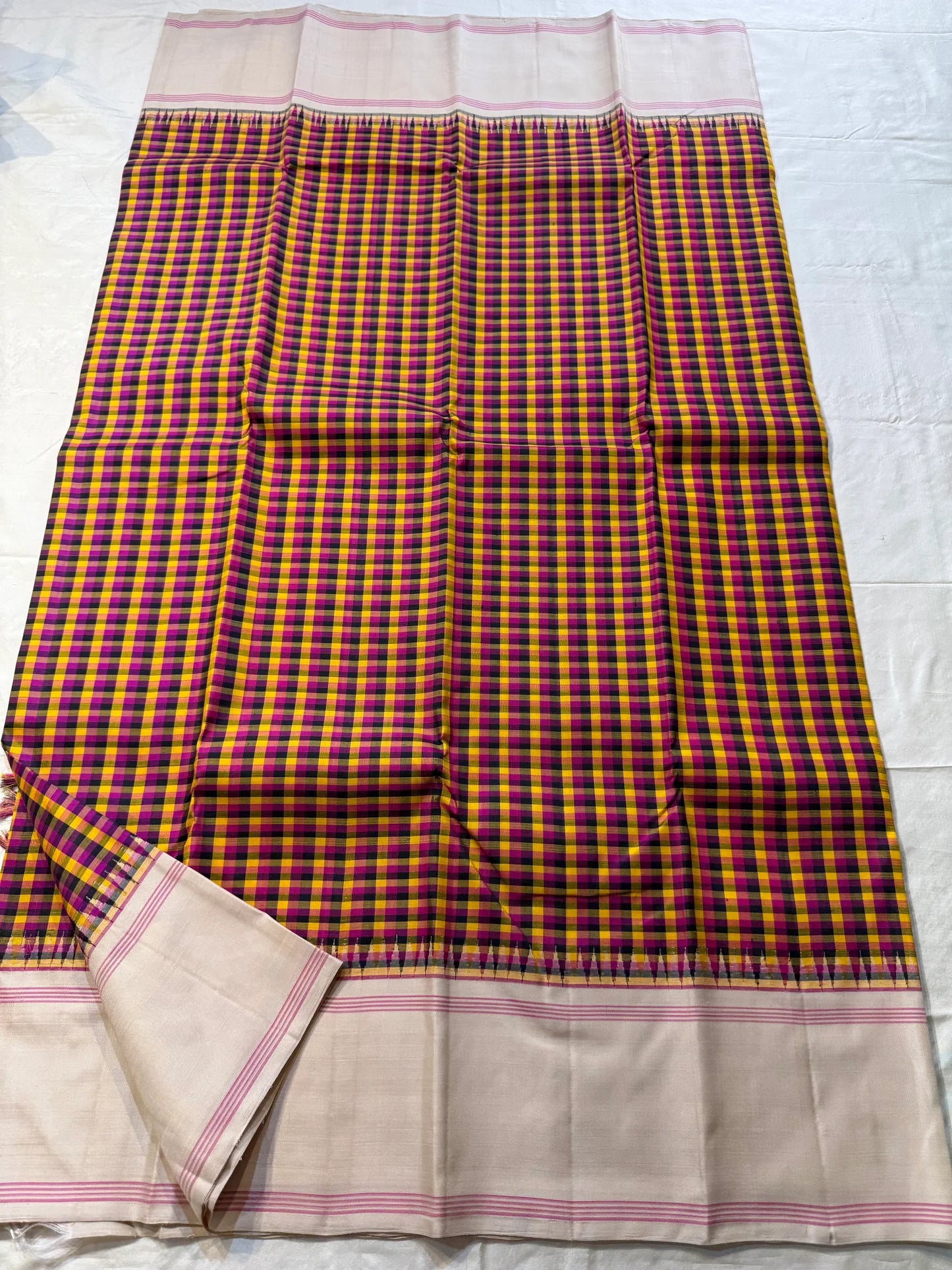 Venpattu Kattam Thazampoo Reku — Pure Kanchipuram Silk Saree
Multicolor kattam body: rani pink • manjal yellow • ink blue/black • deep purple/green accents
(venpattu) borders with pink selvedge lines & thazampoo reku 
Silk Mark Certified  free shipping