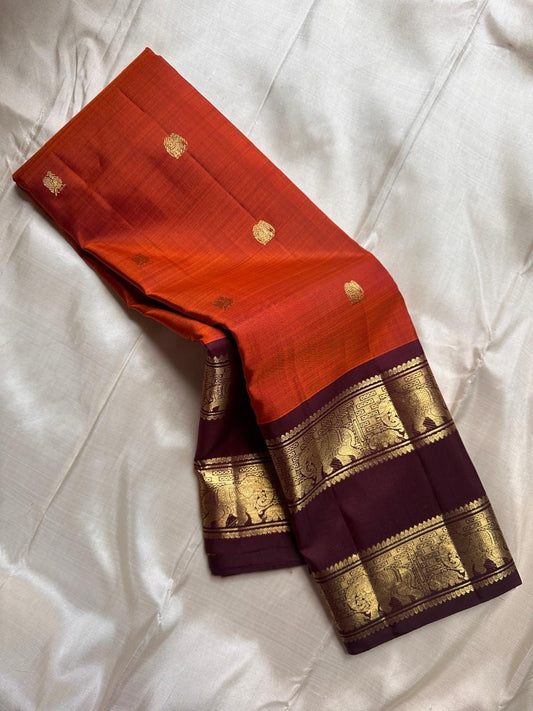 Close view of amber brown Kanchipuram silk saree with traditional zari butta motifs