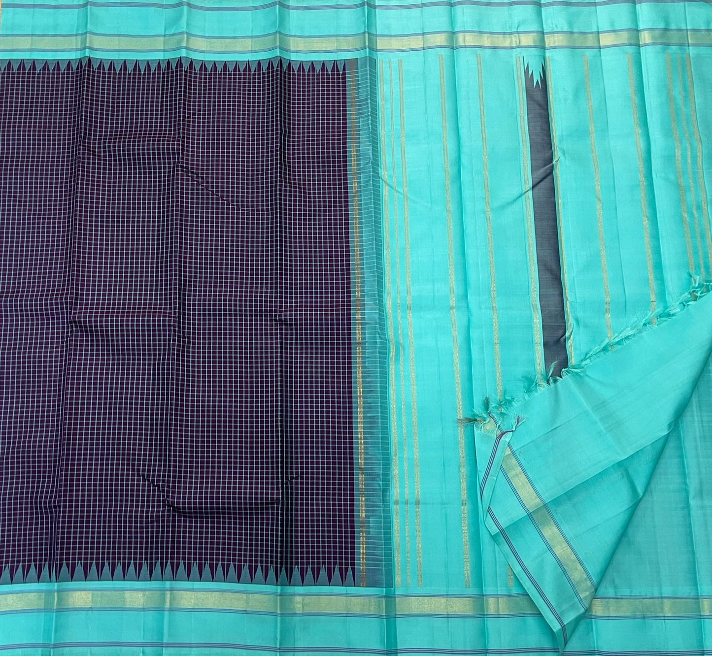 Pure Handwoven Kanchipuram Silk Saree – Deep Aubergine Body with Micro Checks
Contrasting Aqua Blue Korvai Borders with Temple Motifs & silk thread Stripes
Elegant Striped Aqua seer Pallu
Silk Mark Certified ✅ ships in 2 weeks.