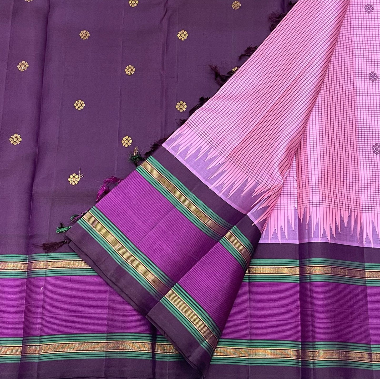 Vadamalli Reku kattam– Pure Silk Kanchipuram Saree
Plum-purple body with gold floral buttas & rettai-pettu borders
Pink checked reku pallu; contrast checked blouse included
Silk Mark Certified | Free Shipping within USA
Ships in 1 Week | Fall & Pico