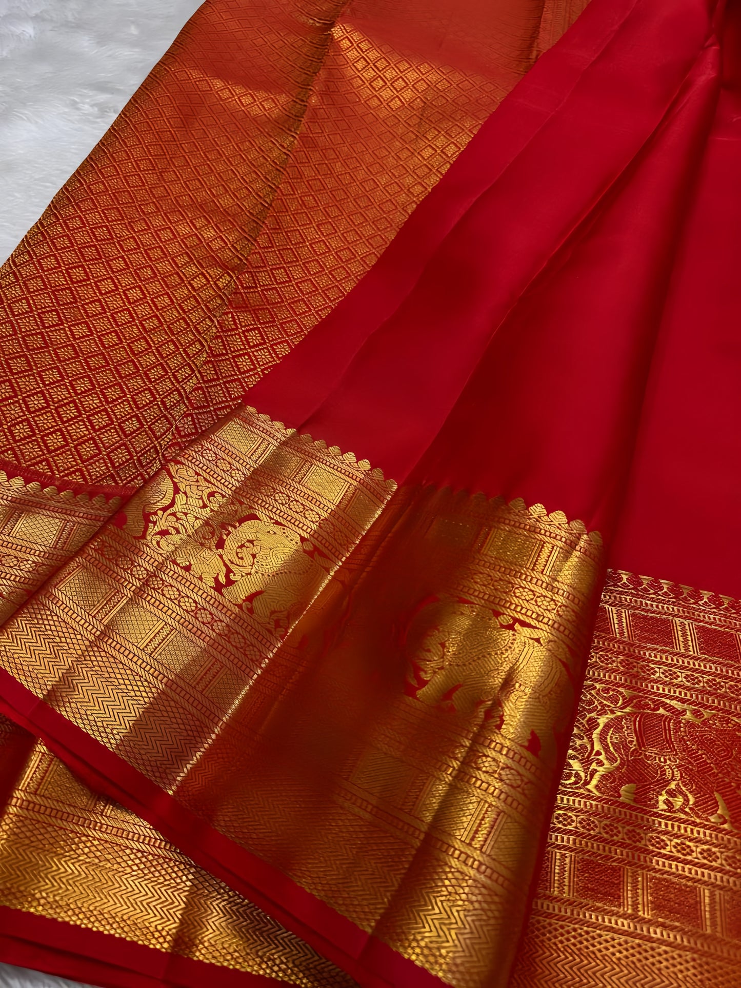 Opulent red Zari kattam with elephant and kamalam motifs spread all over pure silk Kanchipuram saree