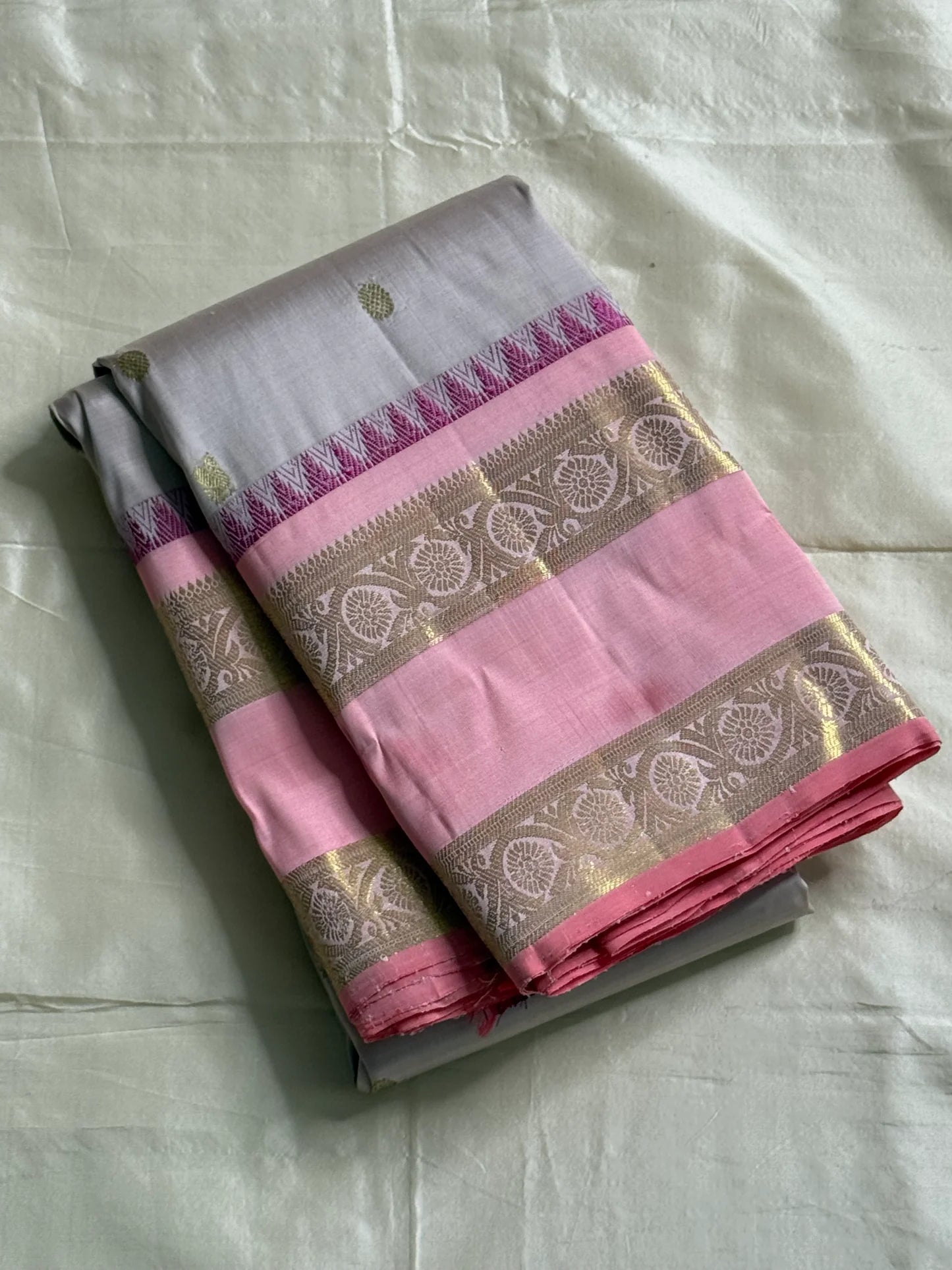 Pink pearl - Pure Kanchipuram Silk with petite chakram zari buttas
Contrast rose-pink border with magenta temple (reku) peaks & floral vine zari
Silk Mark Certified • Free USA Shipping • Ships in Two Weeks