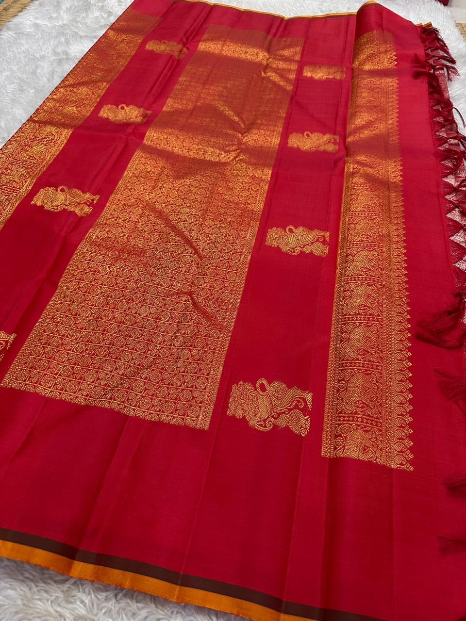 Lavanya– Vermillion Red Handwoven Kanchipuram Silk Saree in red with Gold & Silver Zari, this deep red Kanchipuram silk saree with intricate motifs in gold and silver zari, including Gandaberunda, parrots, elephants &lotuses as seen on Nita Ambani