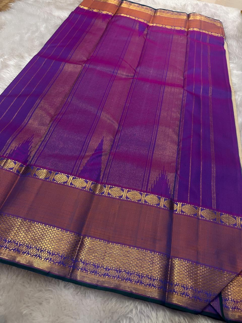 Vaidhehi – Ivory Kanchipuram Silk Saree
A classic ivory silk saree with a shot purple-orange Rudraksham border and a rich Thazhampoo reku pallu—timeless elegance woven with tradition