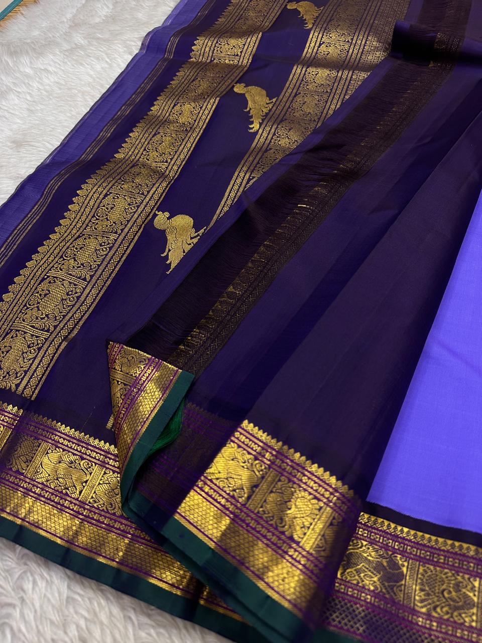 Kili kanchipuram beautiful purple and violet combination adorned with kili and kamalam butta , vanasringaram border and green selvedge with parrots parading in Pallu