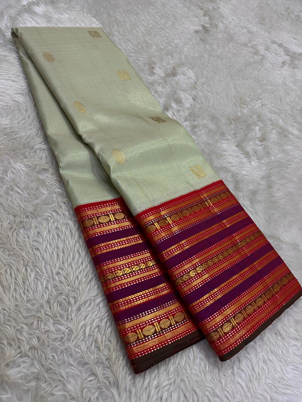 Pure silk kanchipuram grey with sampanga green vairaoosi with detailed ornate varisaipet border thandavalam zari , mayil Butta