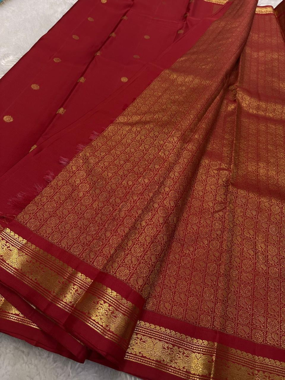 Ratna Rekha — Pure Silk Kanchipuram Saree
Deep kumkum red body with gold coin buttas, rich woven zari jaal pallu, and antique-gold floral borders.
Silk Mark Certified • Blouse Stitching ($30) • Free USA Shipping • Ships in 1 Week