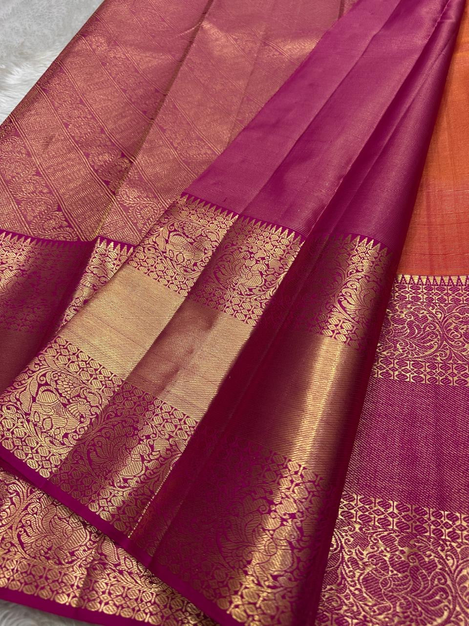 Vairaoosi - silk Kanchipuram thanga velli ( sonaroopa) zari butta in a mesmerizing rust red korvai getti (thick ) zari border with mayil motif