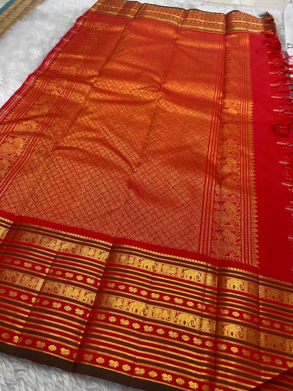 Vermilion Varisaipet – Pure Kanchipuram Silk Saree
Deep Vermilion Red Body with Golden Zari Checks & Buttas
Grand Varisaipet Border with Temple & Floral Motifs
Radiant Red-Orange Pallu Adorned with Lustrous Zari
Silk Mark Certified, delivery in 2 weeks