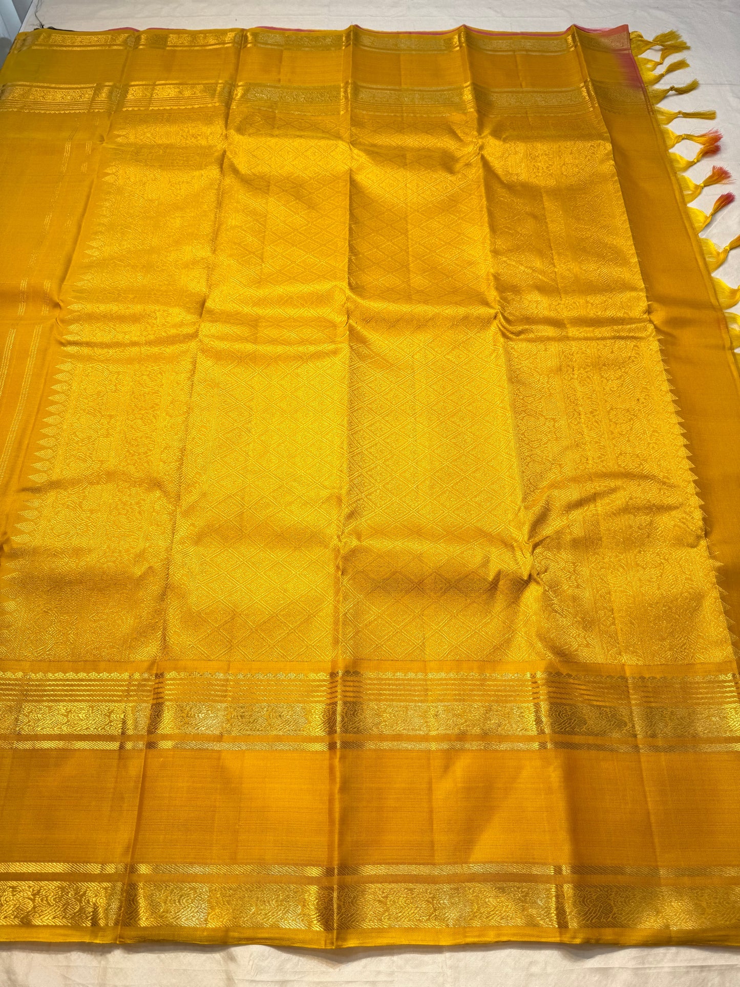 Kanakam mellow yellow body with zari rosette buttas and antique-gold borders; intricate pallu in diamond brocade with tassels.rose pink blouse
Silk Mark Certified • Free Shipping within USA • Ships in Two Weeks ✅