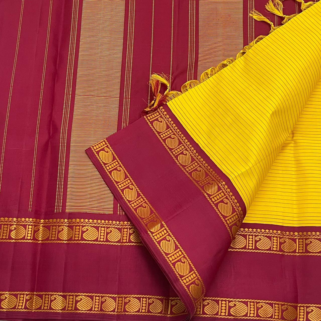 Arakku Kanakam — Pure Silk Kanchipuram Saree
Basanti yellow body with fine varisai pinstripes and rich arakku korvai borders adorned with gold shankh motifs ✨
Silk Mark Certified • Free USA Shipping • Ships in Two Weeks ✅