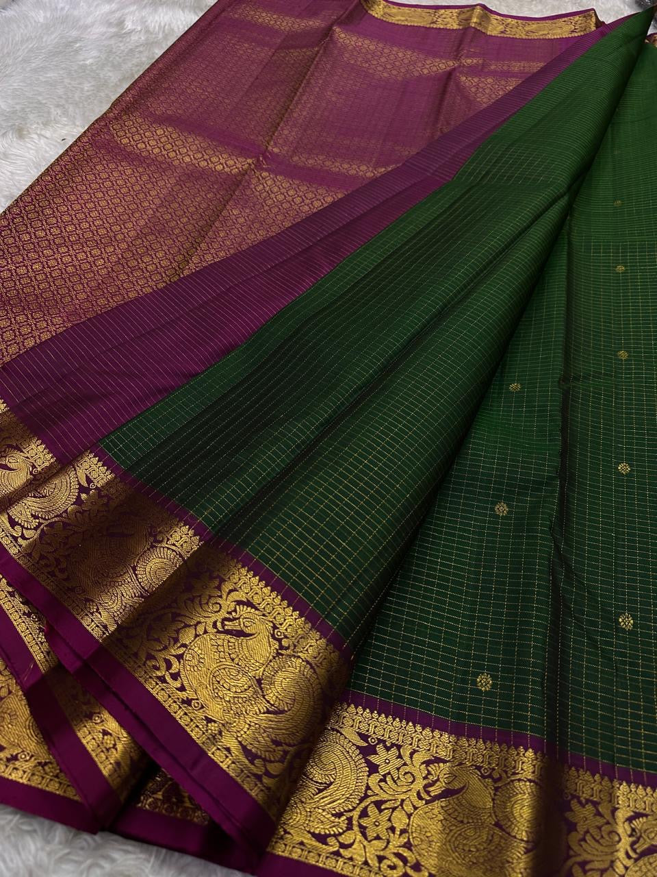 Hemavalli Zari Kattam: Stunning Emerald Green & Rani Pink Korvai Pure Silk Kanchipuram with Gold Zari Checks
Silk Mark Certified for Quality Assurance, Enjoy Free Shipping within USA.
Ready to Ship in 2 Weeks with Majestic Peacock Borders.