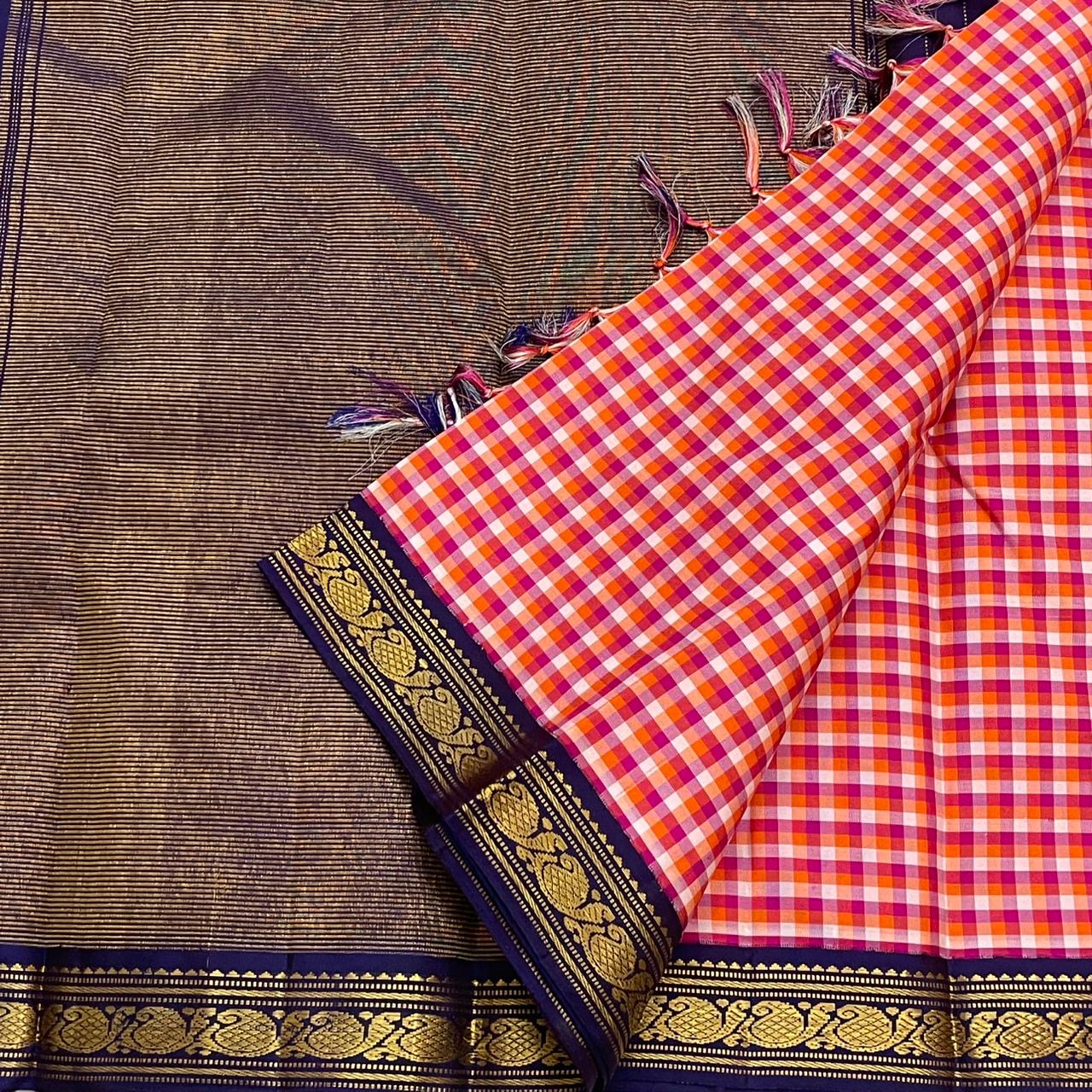 Rani Kanthi — Pure Silk Kanchipuram Saree
Sunset-orange, rani-pink & haldi-yellow kattam checks ✨
Navy korvai borders with intricate gold zari vines
Rich navy pallu with zari pinstripes & tasseled finish
Silk Mark Certified • Free USA Shipping in 1 week