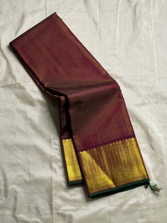 Shyama Vairaoosi — Pure Silk Kanchipuram
Deep Shyama brown with micro Vairaoosi pinstripes
Temple-column antique gold zari border, bottle-green selvedge
 Grand striped zari pallu with hand-tied tassels
Silk Mark Certified • free shipping