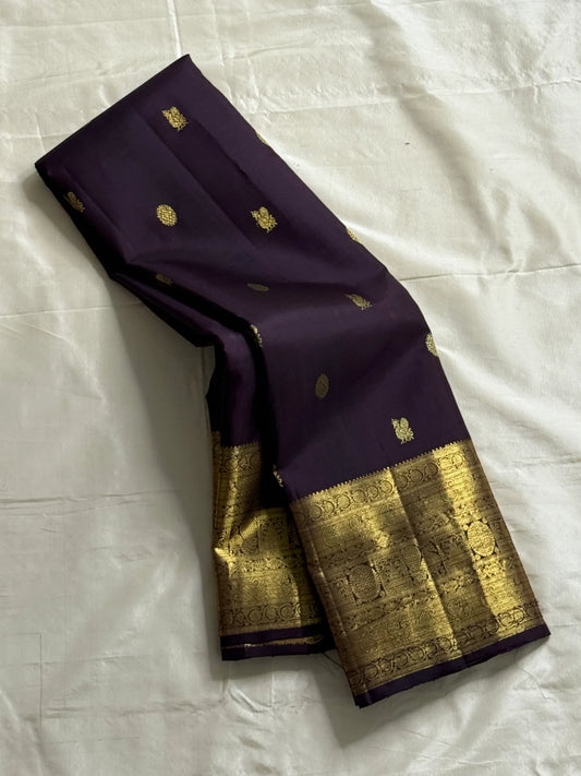 Deep Plum Coin Zari (Pure Kanchipuram Silk)
 Aubergine/plum body with gold chakram & mayil buttas
Self deep-purple border with antique-gold kasu-mālai (coin) motifs
Silk Mark Certified • Free USA Shipping • Ships in Two Weeks
