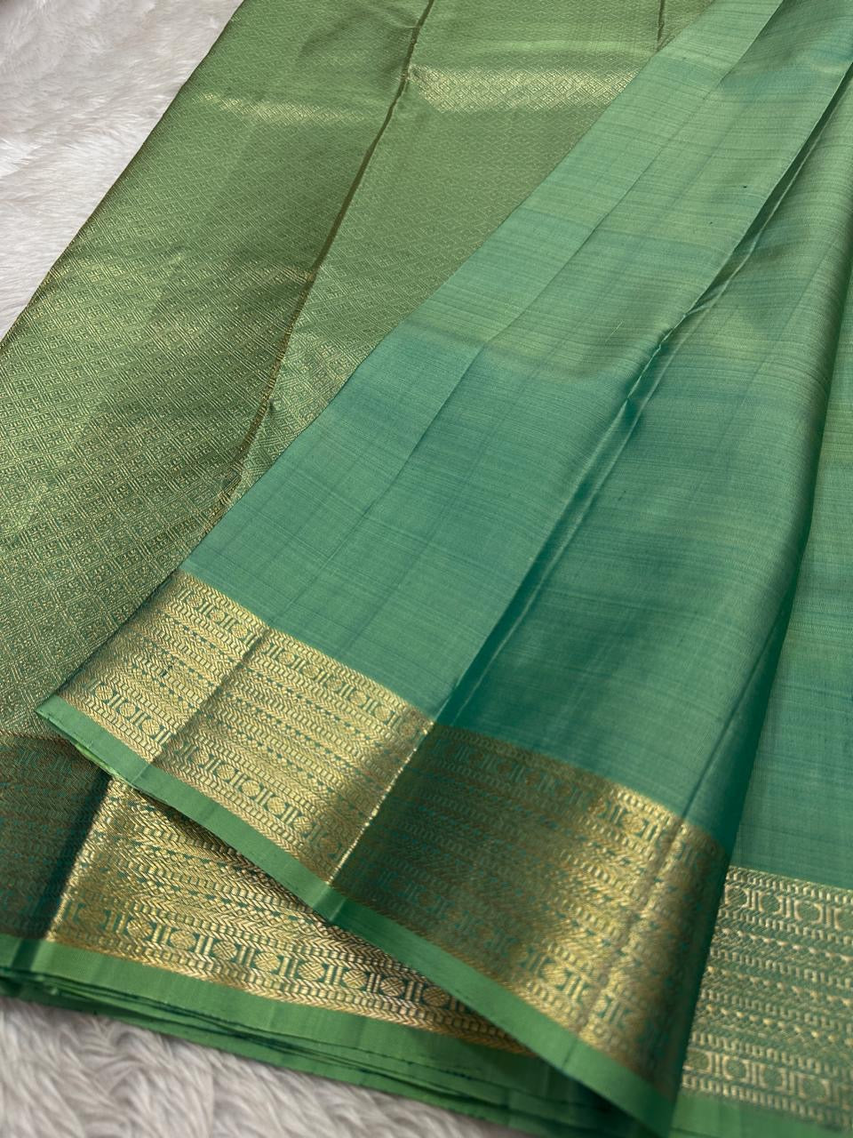 Vibha pastel sage green Pure Kanchipuram Silk Saree Blending the Grandeur of South Indian Weaving with Paithani-Inspired Floral Zari Borders and a Lustrous Rose Gold zari Pallu