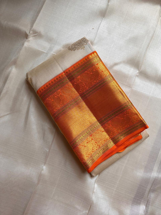 Ivory Marigold — Pure Silk Kanchipuram Saree
Pearl-Ivory Body with Gold Buttas & Kesari-Orange Peacock Zari Border ✨
Silk Mark Certified • Free USA Shipping • Ships in 2 weeks