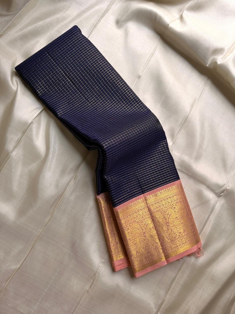 Deep navy blue Zari kattam with pink peach border peacock motif and Pallu
