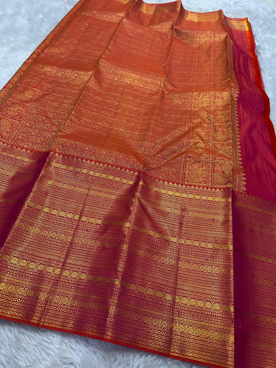 Orange red shot Zari kattam with ornate border pure silk Kanchipuram with mayil chakram zari butta and detailed Pallu