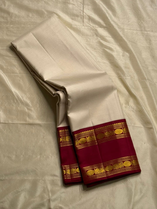 Ivory Vairaoosi Red Rudraksham – Korvai Kanchipuram Silk Saree
Ivory pinstripe body | Red korvai border with rudraksham & coin rows
Rich red zari-brocade pallu | Contrast blouse | Fall & Pico Done
Silk Mark Certified | Free USA Shipping | Blouse Stitching