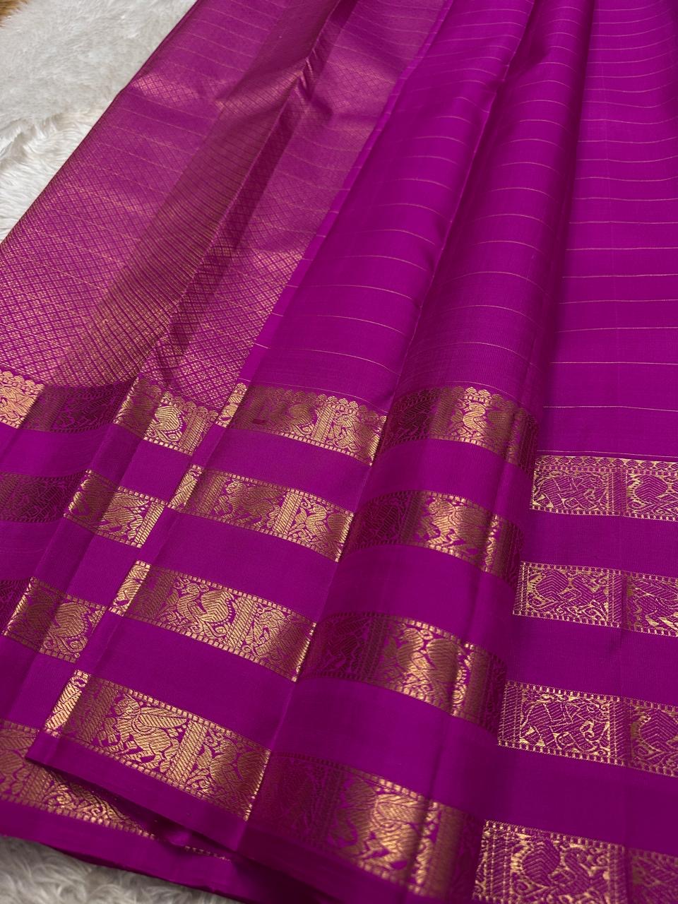 vasantham Fuchsia pink – Handwoven Kanchipuram Silk Saree A poem in Fuchsia silk. The body glows in a serene vibrant Fuchsia, softly accented by delicate gold vertical lines and dainty gold zari buttas that glint like little blessings.