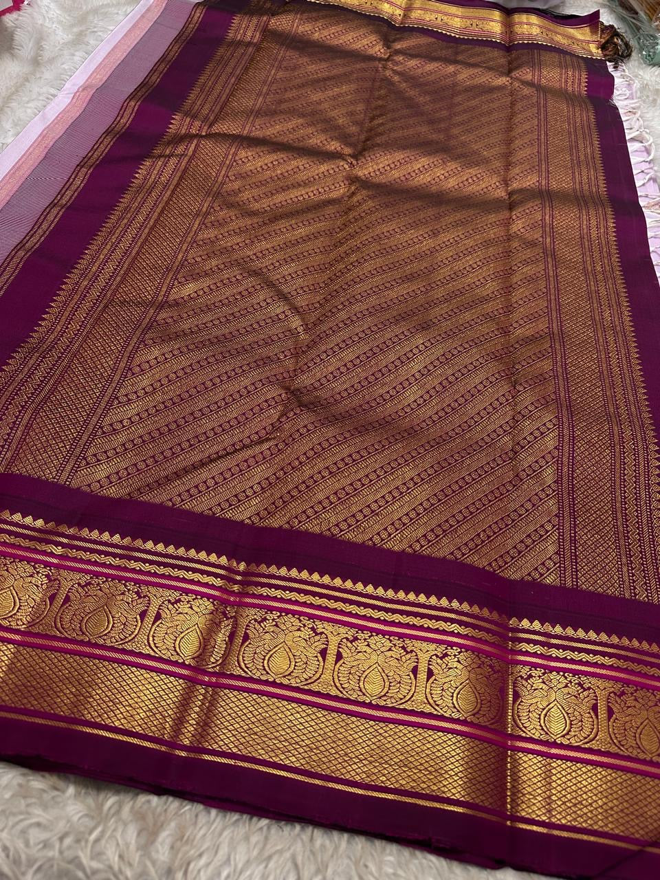 Lavanya Varnam — Pure Silk Kanchipuram Saree
Soft lavender-lilac body with rose-gold paisley buttas and deep wine-maroon korvai borders woven with temple motifs and rich zari.
Silk Mark Certified • Blouse Stitching Available ($30) • Free USA Shipping •