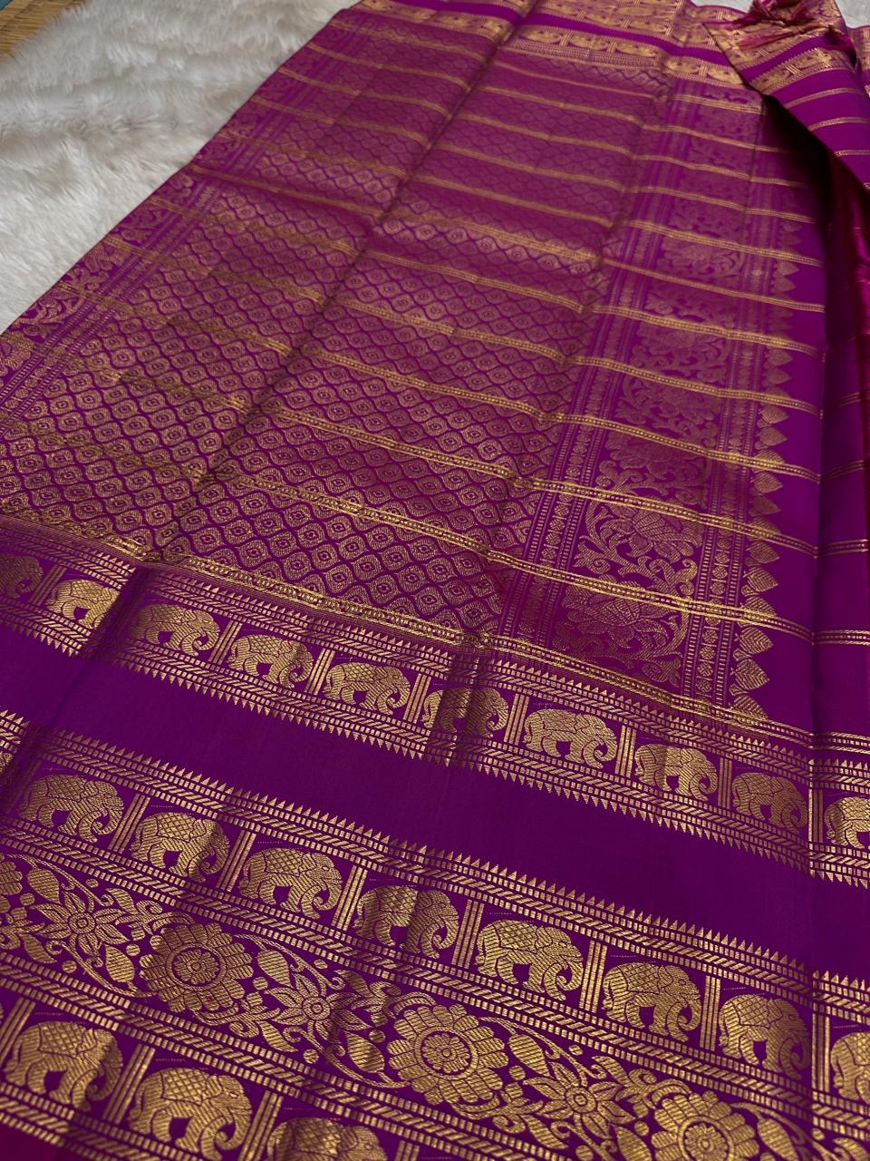 Rani Pink Plum Zari Stripes – Pure Kanchipuram Silk Saree
Plum purple body with rani-pink korvai borders & grand zari pallu
Elephants & floral mandalas woven in gold zari
Silk Mark Certified | Blouse Piece Included | Fall & Pico Done
Free shipping