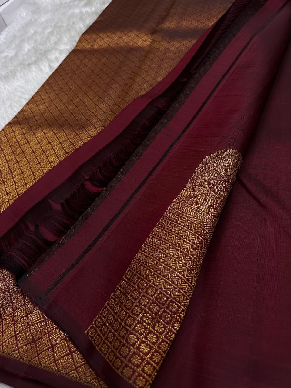 Lotus Glow — Maroon Brown | Pure Kanchipuram Silk Saree
A rich maroon-brown canvas with gold zari peacocks, elephants & lotus motifs 🌸
Silk Mark Certified • Free USA Shipping • Ships in Two Weeks