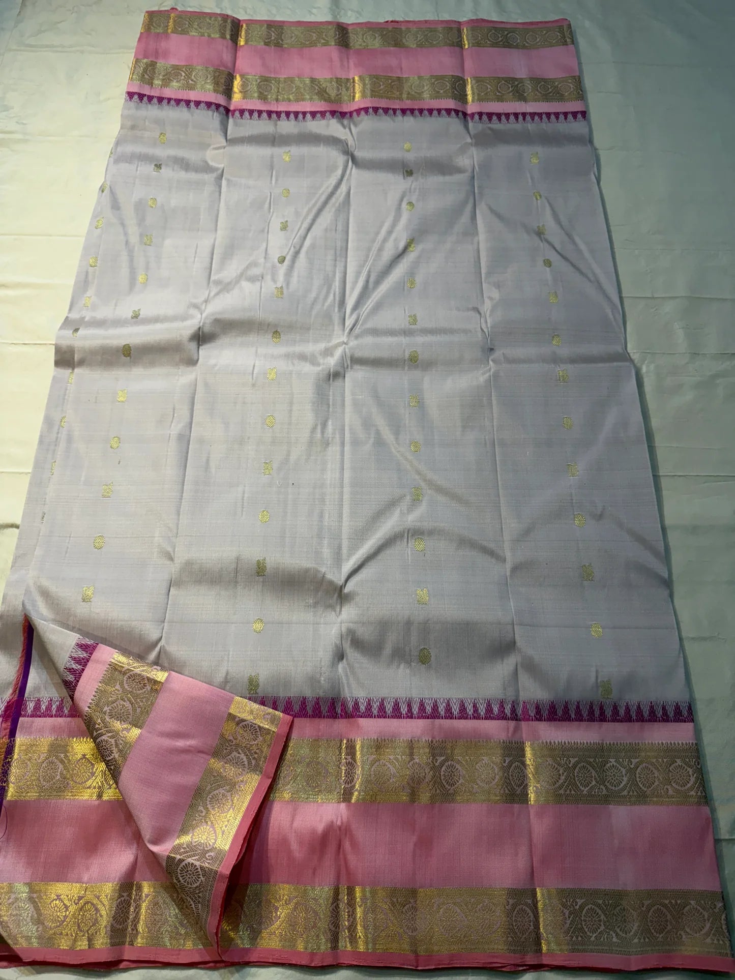 Pink pearl - Pure Kanchipuram Silk with petite chakram zari buttas
Contrast rose-pink border with magenta temple (reku) peaks & floral vine zari
Silk Mark Certified • Free USA Shipping • Ships in Two Weeks
