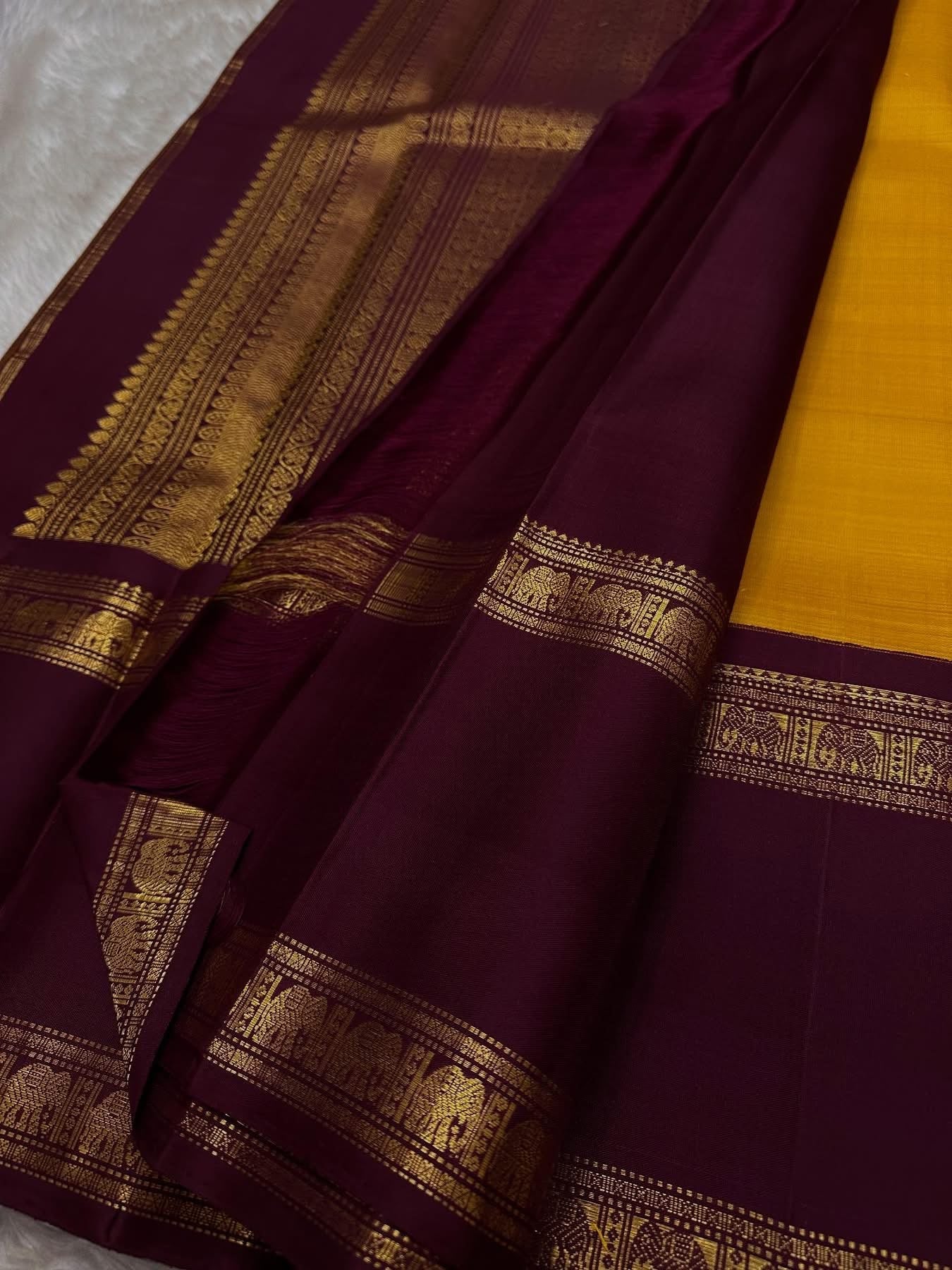 Bhanu – Mustard Gold Handwoven Kanchipuram Silk Saree with Deep Coffee Brown Borders, Intricate Elephant Motif Zari, and a Grand Temple-Inspired Pallu