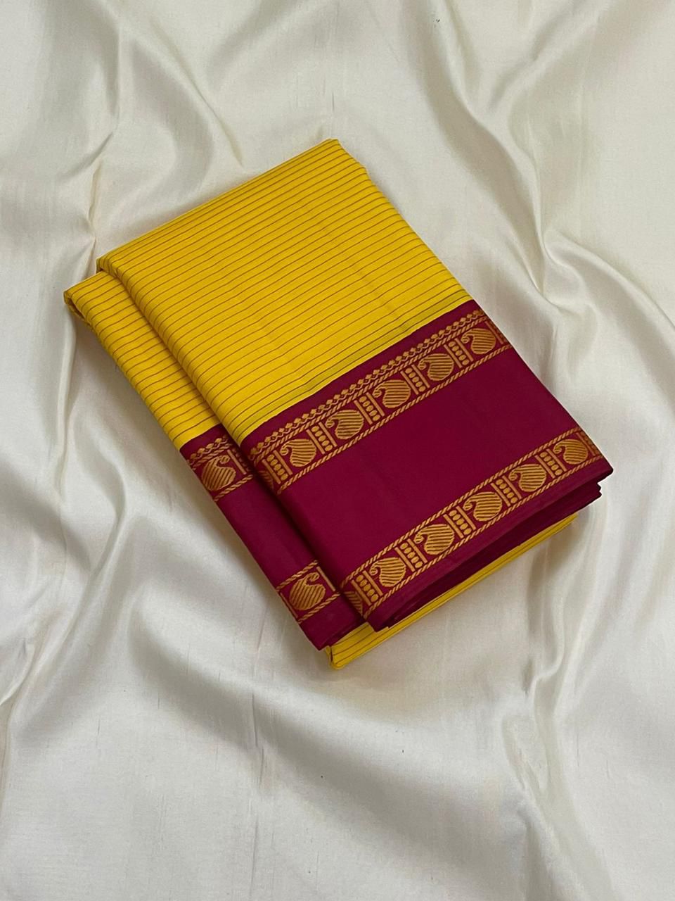 Arakku Kanakam — Pure Silk Kanchipuram Saree
Basanti yellow body with fine varisai pinstripes and rich arakku korvai borders adorned with gold shankh motifs ✨
Silk Mark Certified • Free USA Shipping • Ships in Two Weeks ✅