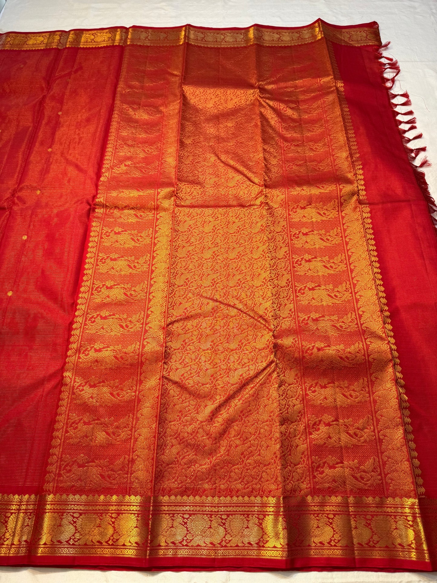 Vermillion Swarna Vairaoosi — Pure Kanchipuram Silk Saree
Vermillion red body with fine vairaoosi stripes, gold rosette buttas, and Gandaberunda borders in antique zari.
Silk Mark Certified • Free Shipping within USA • 2 weeks