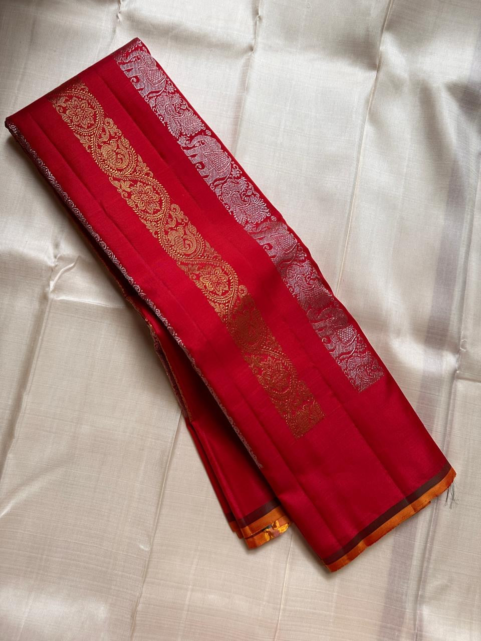Lavanya– Vermillion Red Handwoven Kanchipuram Silk Saree in red with Gold & Silver Zari, this deep red Kanchipuram silk saree with intricate motifs in gold and silver zari, including Gandaberunda, parrots, elephants &lotuses as seen on Nita Ambani