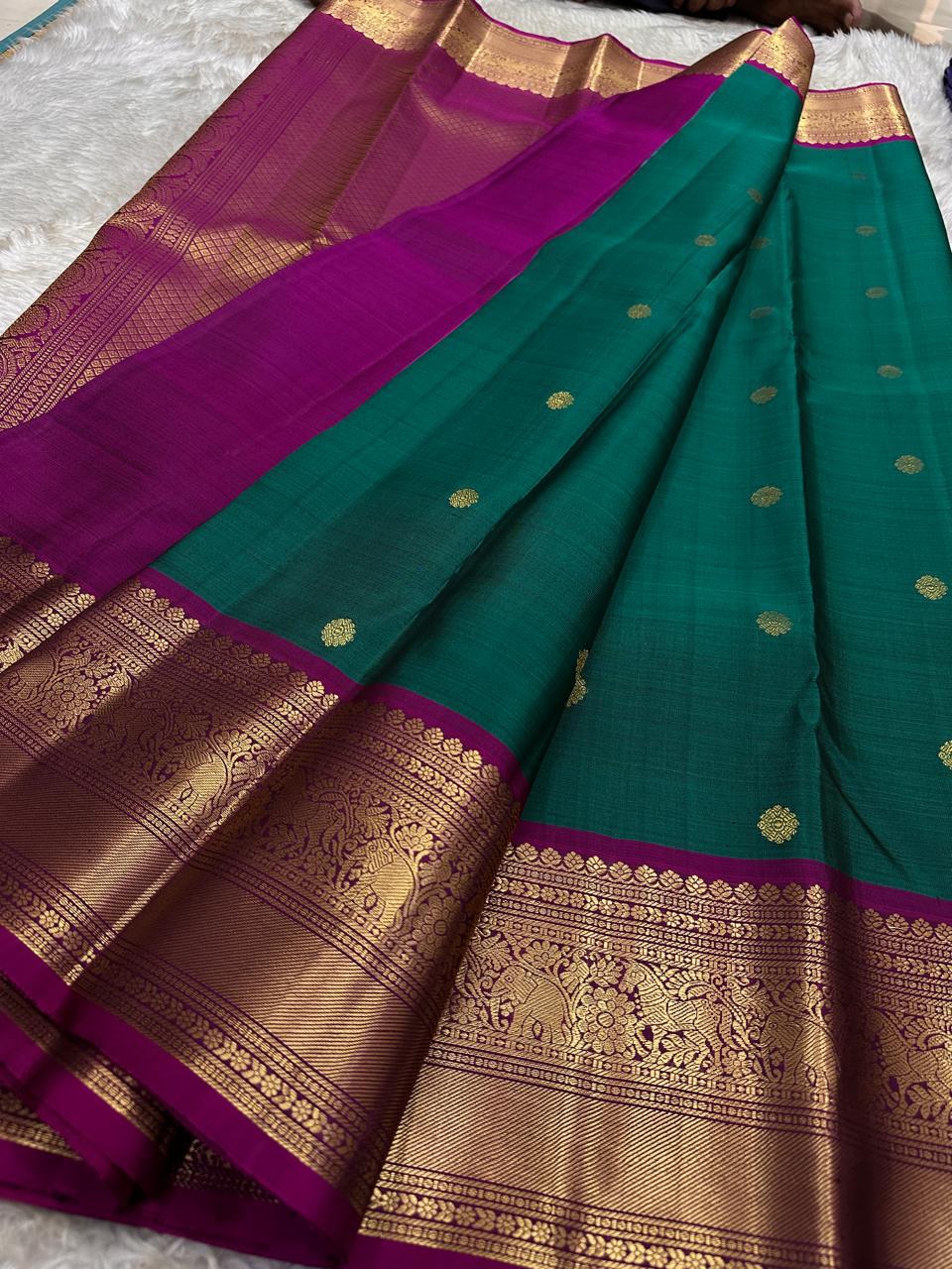 Peacock Green Pushpam – Pure Silk Kanchipuram Saree
 floral butta body with magenta contrast floral zari border
Grand woven zari pallu with traditional medallions & motifs
Silk Mark Certified | Free Shipping within USA
Ships in 1 Week | Fall & Pico