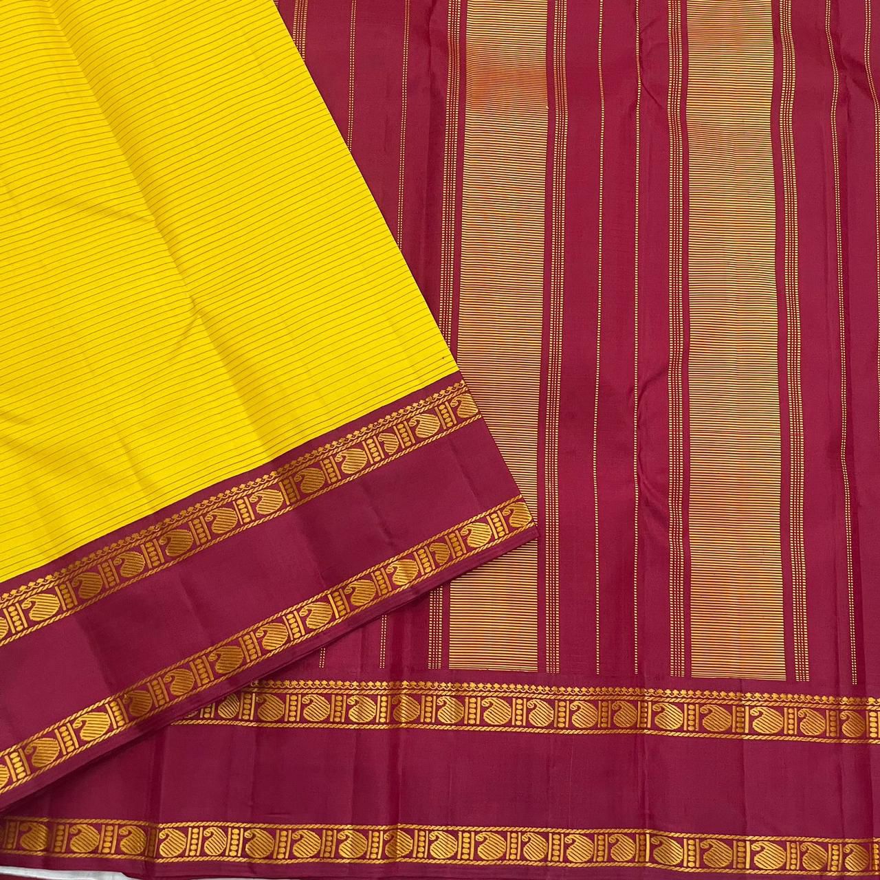 Arakku Kanakam — Pure Silk Kanchipuram Saree
Basanti yellow body with fine varisai pinstripes and rich arakku korvai borders adorned with gold shankh motifs ✨
Silk Mark Certified • Free USA Shipping • Ships in Two Weeks ✅