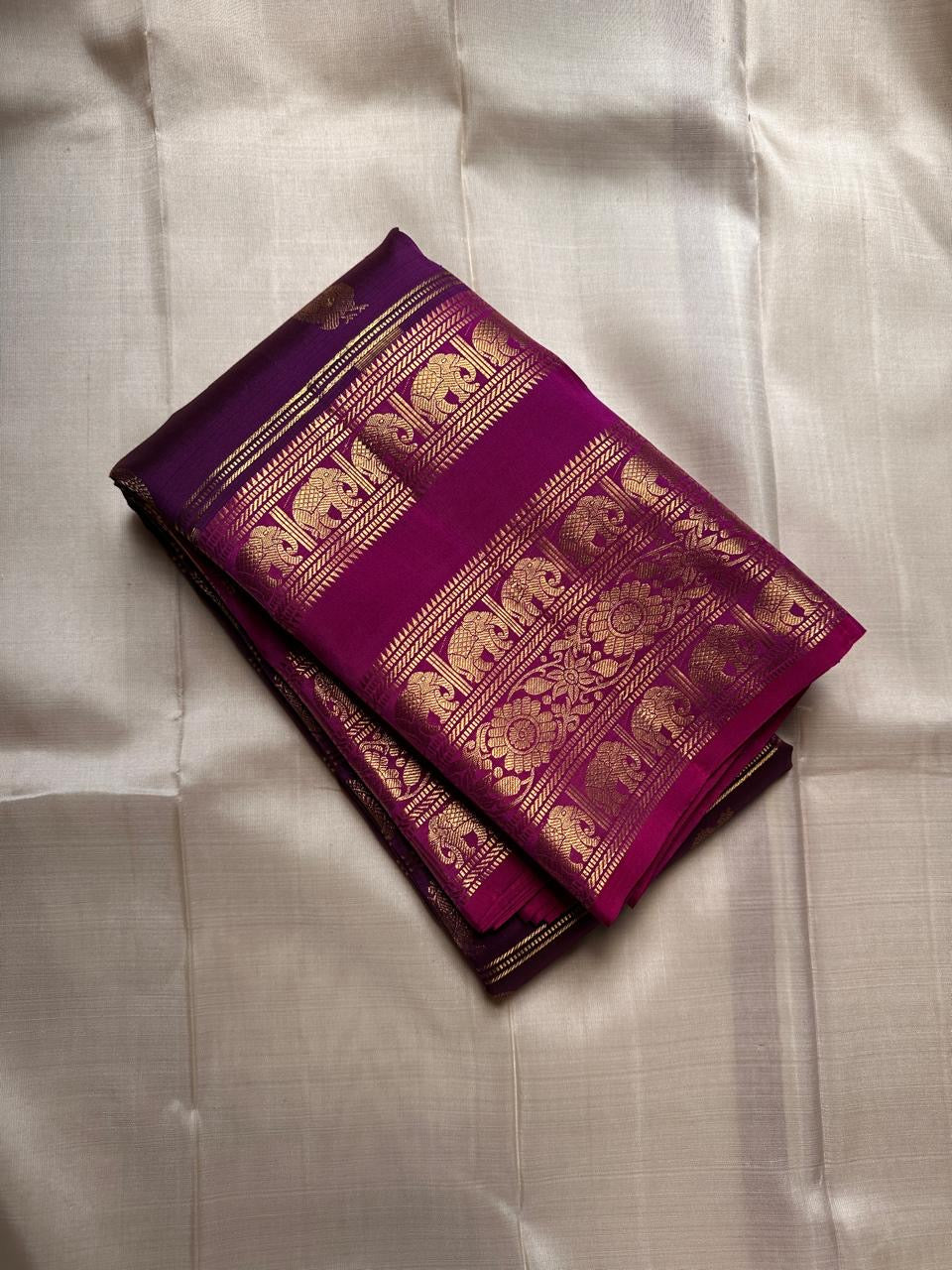 Rani Pink Plum Zari Stripes – Pure Kanchipuram Silk Saree
Plum purple body with rani-pink korvai borders & grand zari pallu
Elephants & floral mandalas woven in gold zari
Silk Mark Certified | Blouse Piece Included | Fall & Pico Done
Free shipping