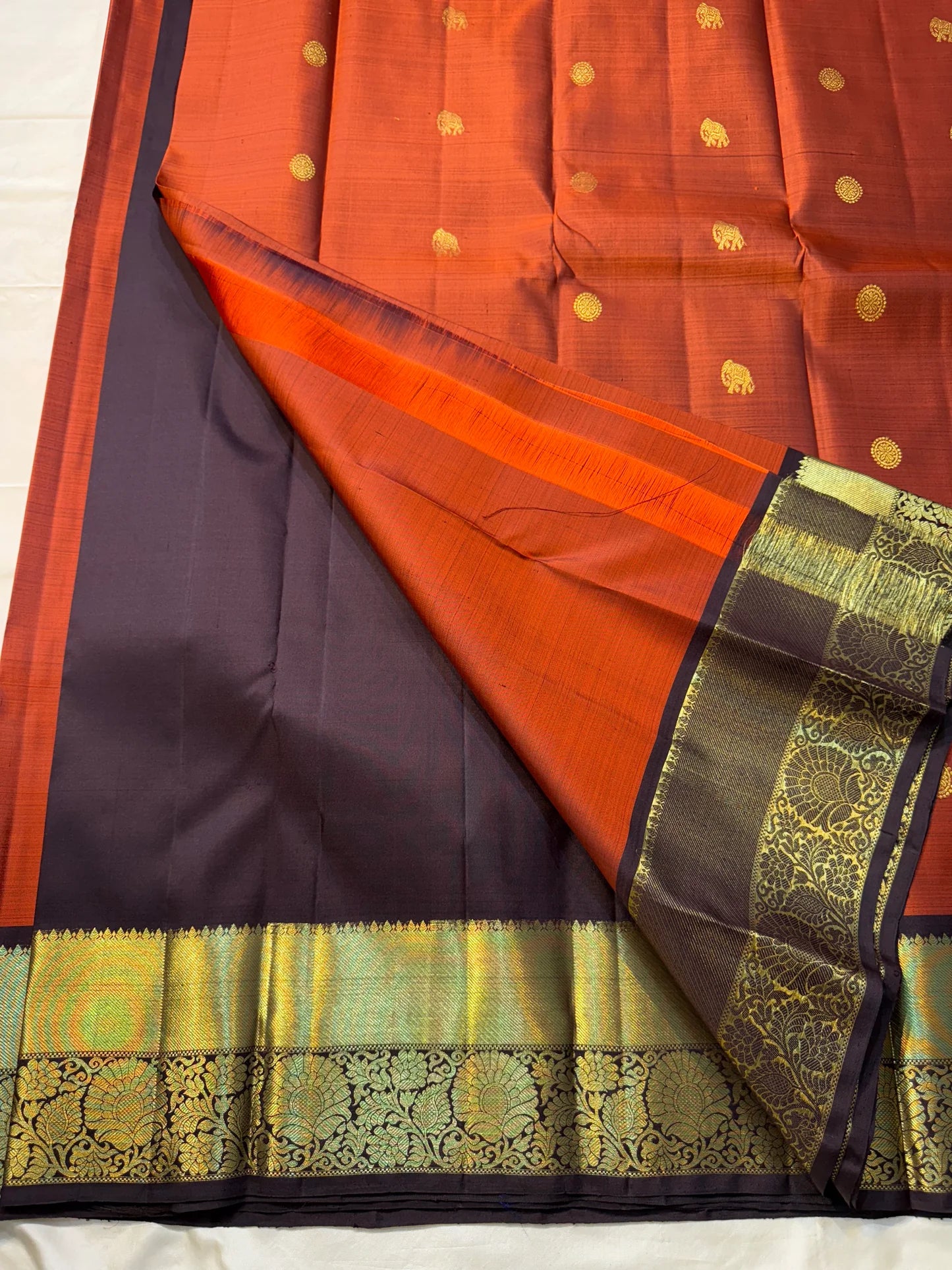 Rust orange Terracotta, Yanai Butta
 — Coffee Brown Korvai Kanchipuram
Deep coffee-brown korvai borders with wide antique-gold kaddi & floral vines
Silk Mark Certified | Free Shipping within USA | Ships in Two Weeks
Blouse Stitching available $30