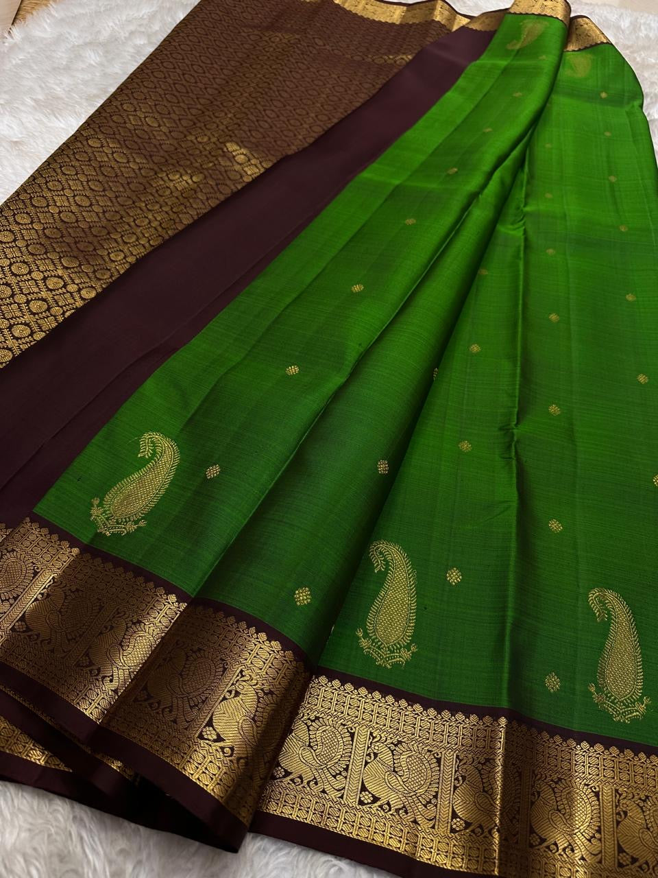Green pure silk Kanchipuram saree with zari motif wirh deep chocolate brown shot purple silk Kanchipuram saree with vanasringaram border and Pallu