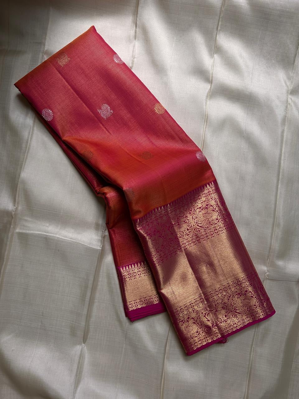Vairaoosi - silk Kanchipuram thanga velli ( sonaroopa) zari butta in a mesmerizing rust red korvai getti (thick ) zari border with mayil motif