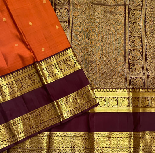 Rust Orange Ramyam – Pure Kanchipuram Silk Saree
Rust-orange body with pavin coin  buttas
Deep brown border with peacock panel & chakra medallions; grand zari pallu
Silk Mark Certified | Blouse Piece Included | Fall & Pico Done
Free Shipping in 1 week