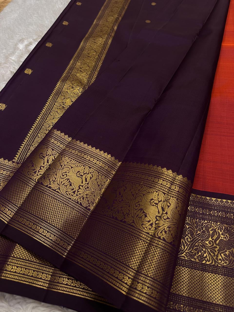 Shyama – Dusky Tangerine Kanchipuram Silk Saree with Purple Vanasringaram Border & Mayil Buttas