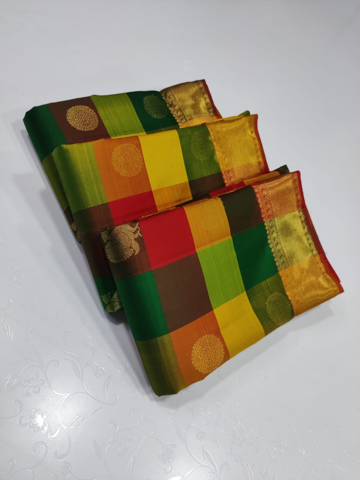 Sunset Mosaic – Paalum Pazhamum – Pure Kanchipuram Silk Saree
Vibrant Multicolored Checks in Yellow, Green, Rust & Maroon
Golden Zari Borders with Traditional Intricate Weaves
Silk Mark Certified, delivery in 2 weeks