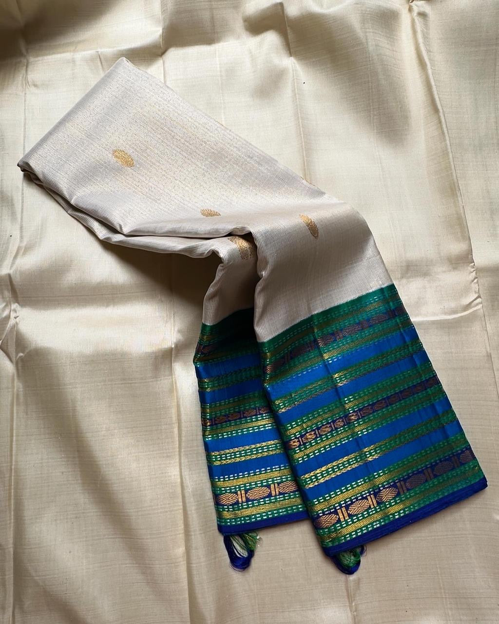 Pure silk kanchipuram handloom saree a unique white vairaoosi with blue sapphire varisaipet border with Rudhraksham motif