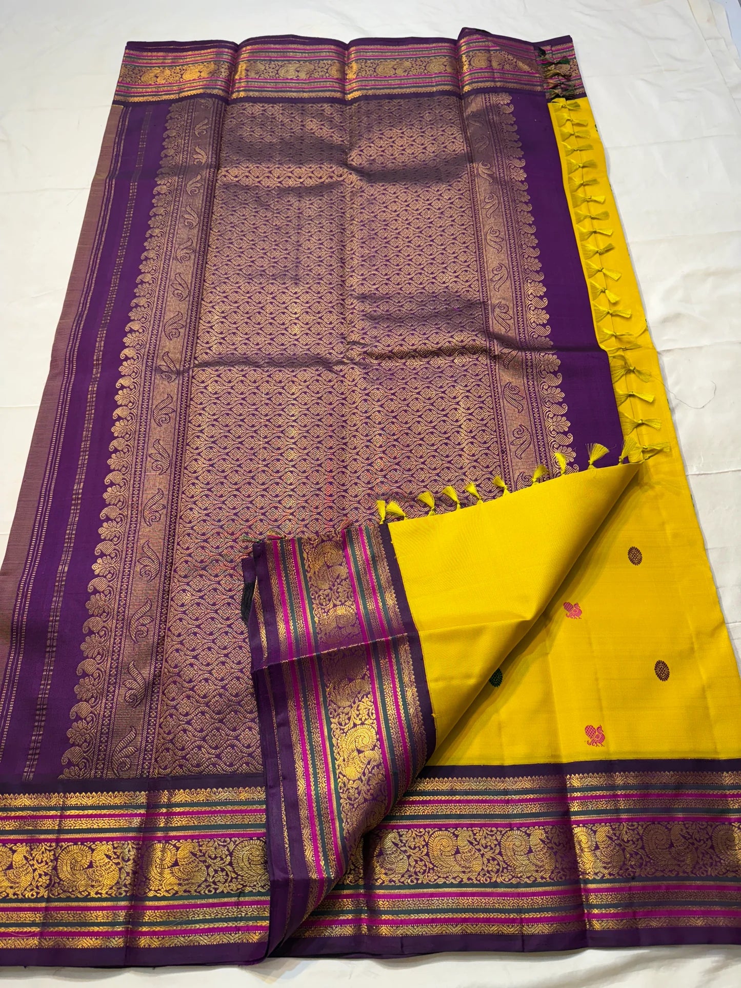 Kili Manjari — Pure Silk Kanchipuram
Haldi Yellow • Parrot & Coin silk thread Buttas • Plum Zari Border
Silk Mark Certified ✅ Free  Shipping ✅ Ships in 1 week ✅
