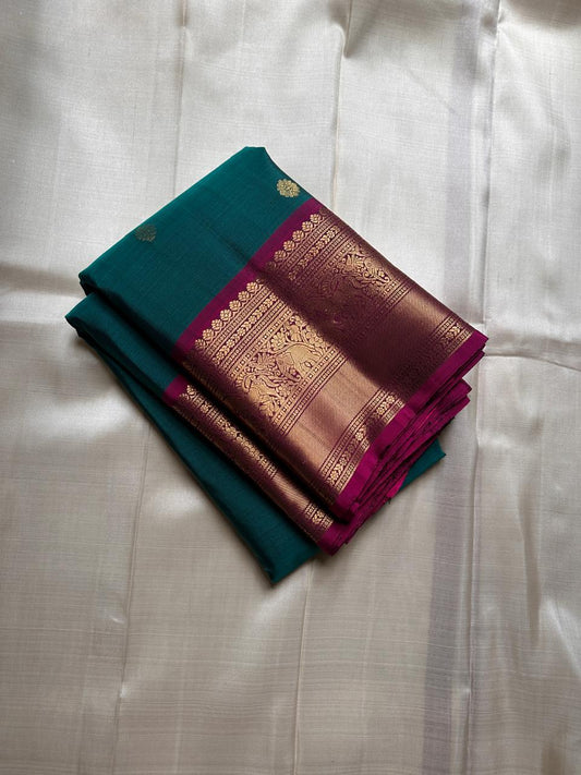 Peacock Green Pushpam – Pure Silk Kanchipuram Saree
 floral butta body with magenta contrast floral zari border
Grand woven zari pallu with traditional medallions & motifs
Silk Mark Certified | Free Shipping within USA
Ships in 1 Week | Fall & Pico