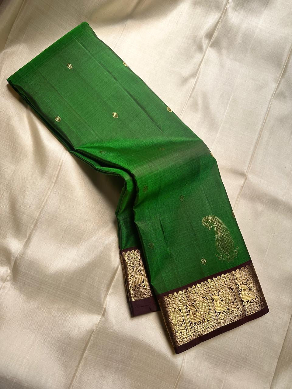 Green pure silk Kanchipuram saree with zari motif wirh deep chocolate brown shot purple silk Kanchipuram saree with vanasringaram border and Pallu